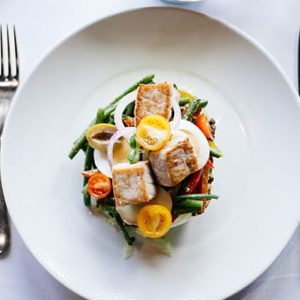 healthy fish dishes on a table with weight scale